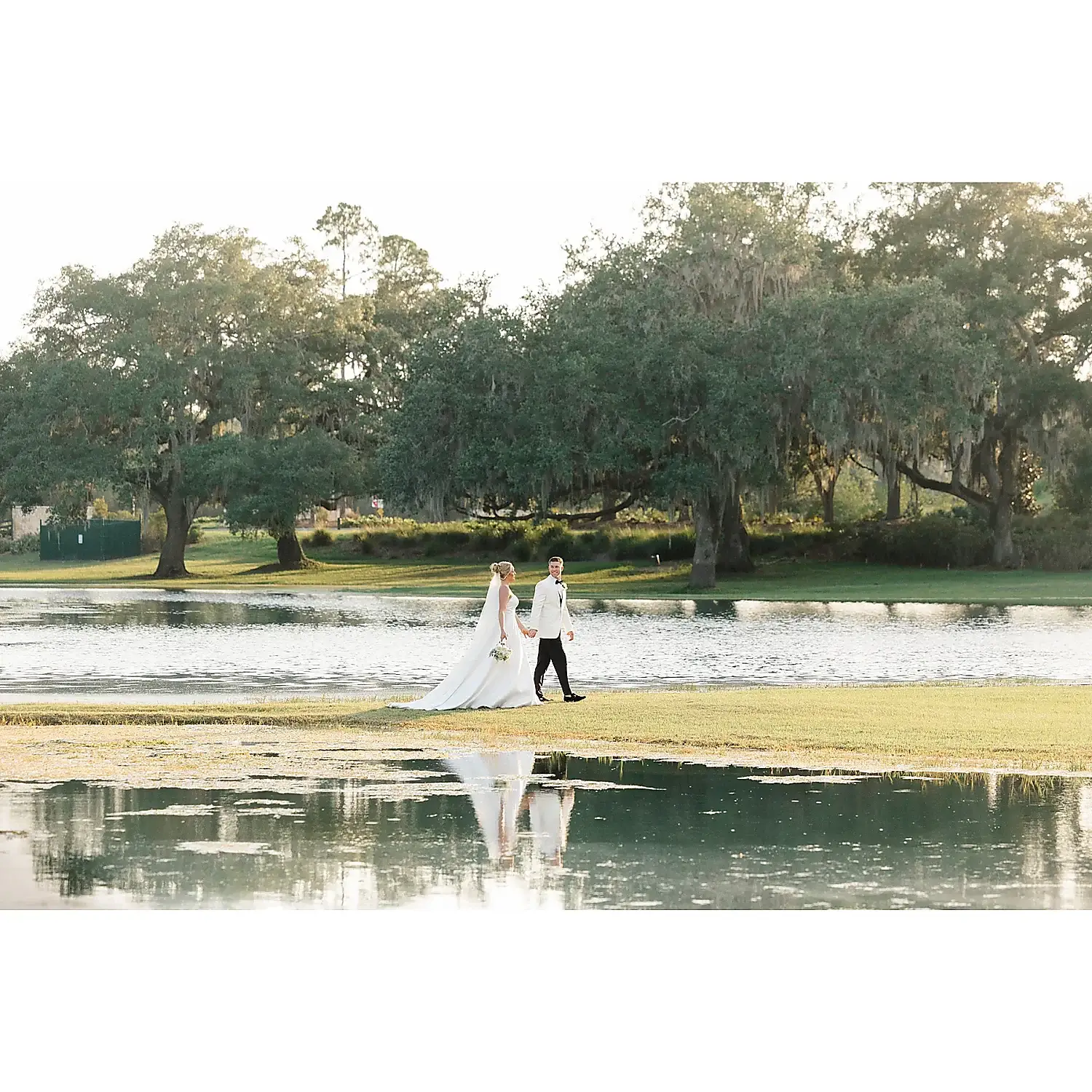 Susan Elizabeth Photography wedding couple walking by lake Florida Wedding Photography