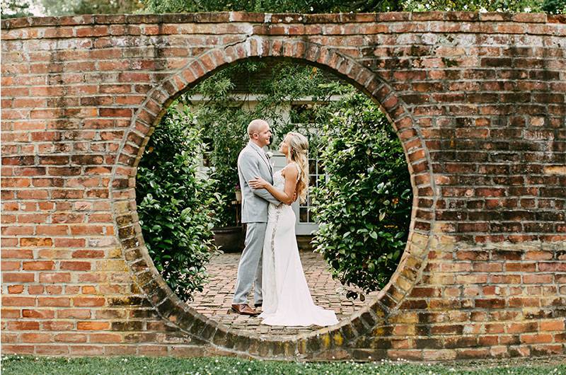 Brick Wall Cedar Hall Bride Groom together