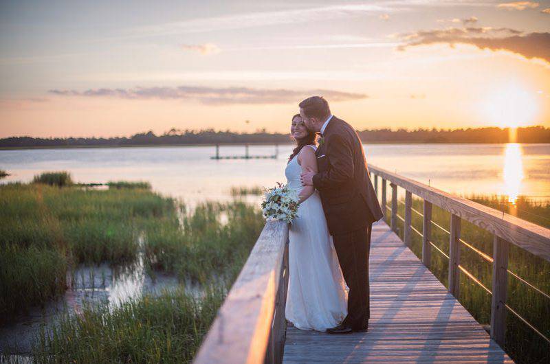  Molly Joseph Photography boardwalk Groom kiss bride sunset