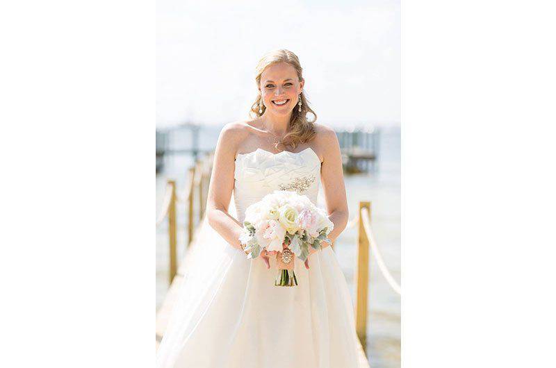 The Barefoot Bride strapless wedding dress bride holding bouquet