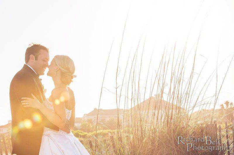 Wild Dunes Resort couple dune bright sky