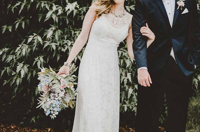 The Big Fake Wedding bride and groom outside bouquet