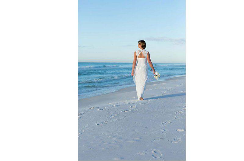 Emerald Coast Convention and Visitors Bureau Bride walking along beach