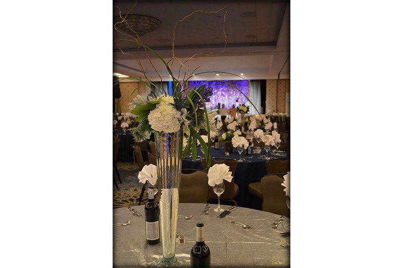 Holliday Flowers and events Centerpiece flowers  in tall flower vase