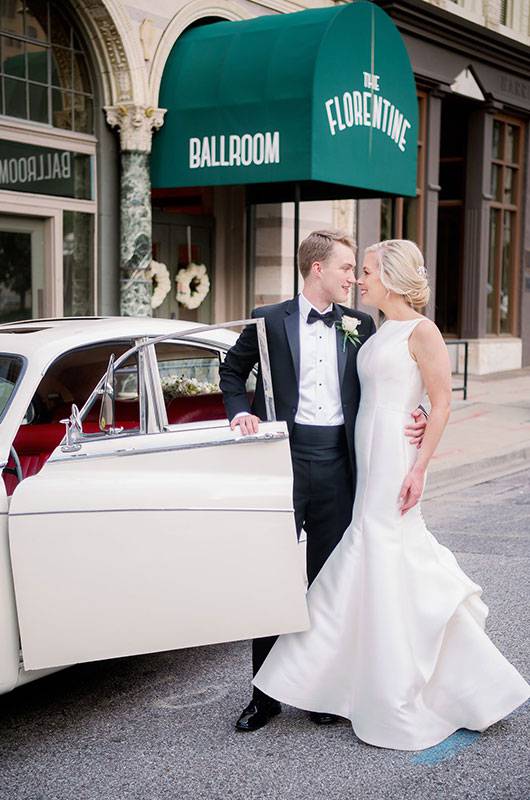 Sloane Bell And Brock Phillips Birmingham Real Wedding Bride And Groom Pose With Car