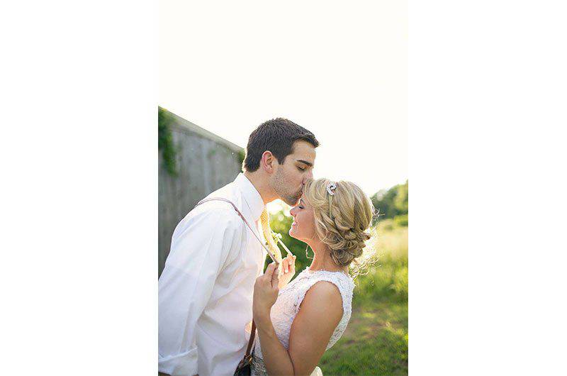 The Barefoot Bride sleeveless gown couple kiss 