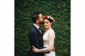 Weddings by Lulu bride and groom by garden wall