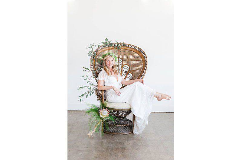 The Barefoot Bride sleeved gown Model in chair