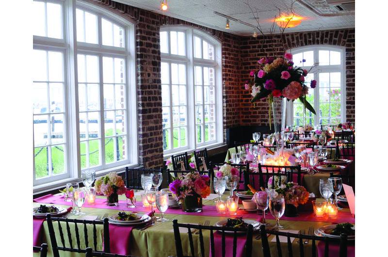 Historic Rice Mill pink reception table runner with floral centerpieces and hanging arrangement