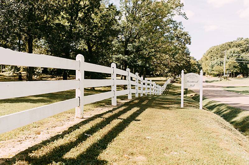 Heartwood hall white rail fence venue sign
