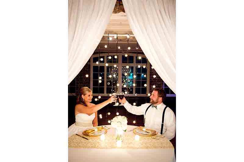 Historic Rice Mill toast bride and groom draped white 