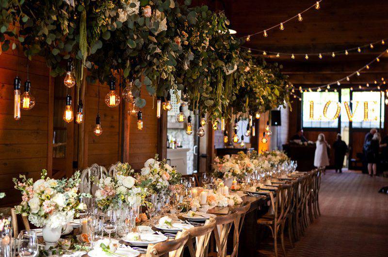 Fete Nashville table setting hanging eucalyptus arrangements with handling lights