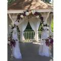 Elegant Beginnings Weddings and Events gazebo draped tall floral decorations