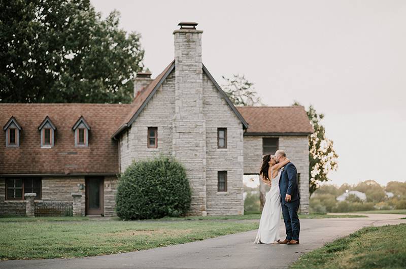 Tina Shtayyeh And Geno Tartell Bride And Groom Kissing In Front Of House