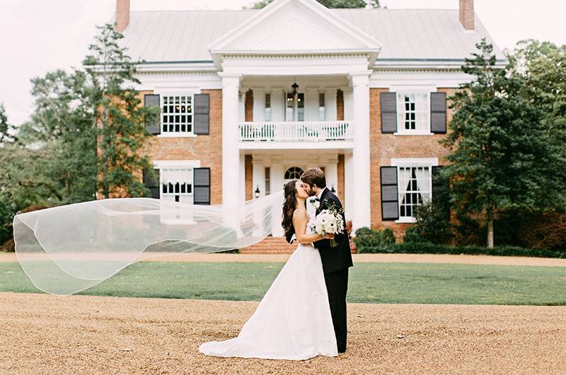 Cedar Hall Kiss Outside venue Lawn bride and groom long veil