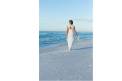 Emerald Coast Convention and Visitors Bureau Bride walking along beach